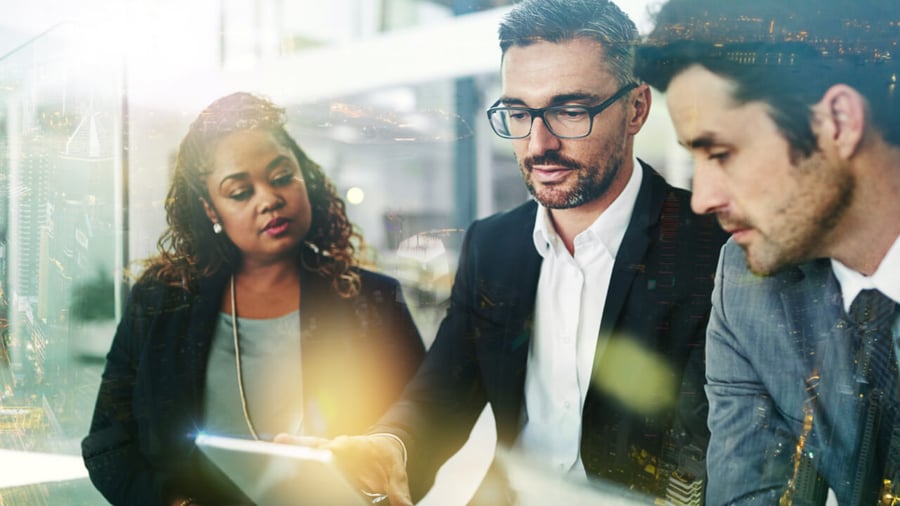 A diverse group of executives monitoring data analytics and make plans for a successful future
