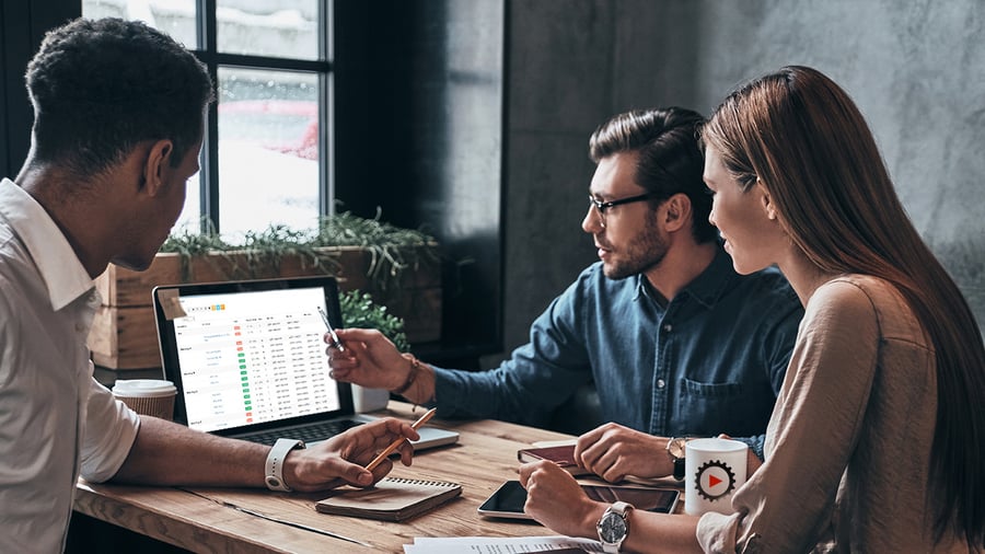 An IT employee directs 2 other employees on how assets are sorted on their screen.