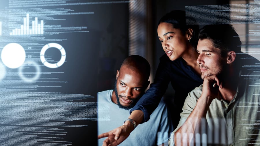 A diverse group of IT techs are inspecting some code on their computer